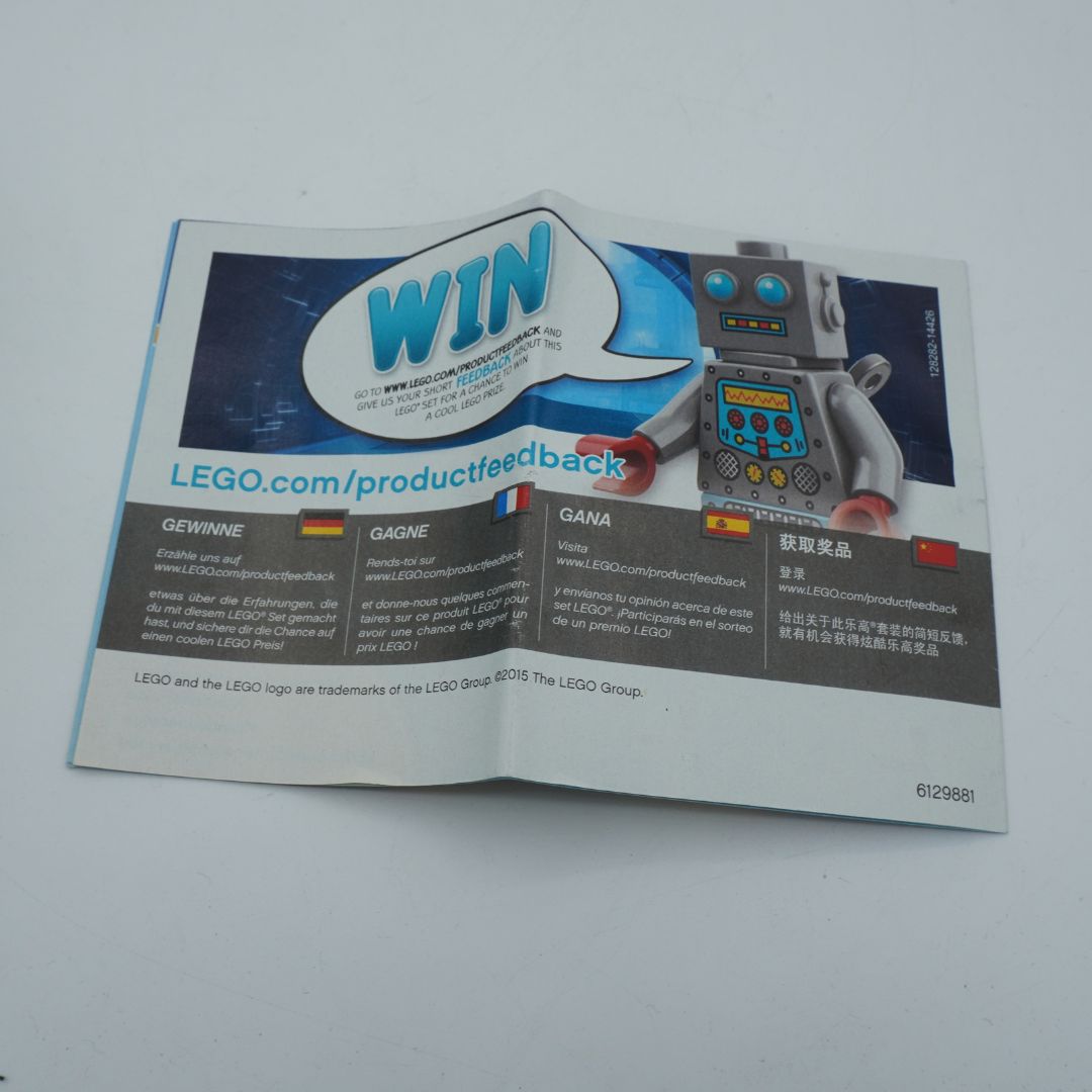 A folded printed LEGO product feedback card or booklet on a plain light background, featuring a robot illustration, a large 'WIN' speech bubble, and website text LEGO.com/productfeedback.