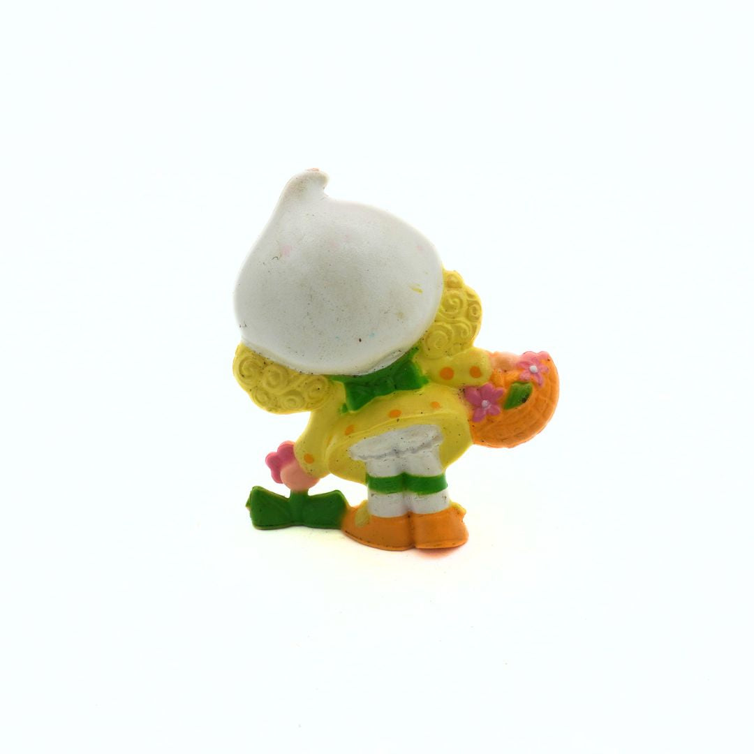 Colorful figurine of a character with a white hat on a white background