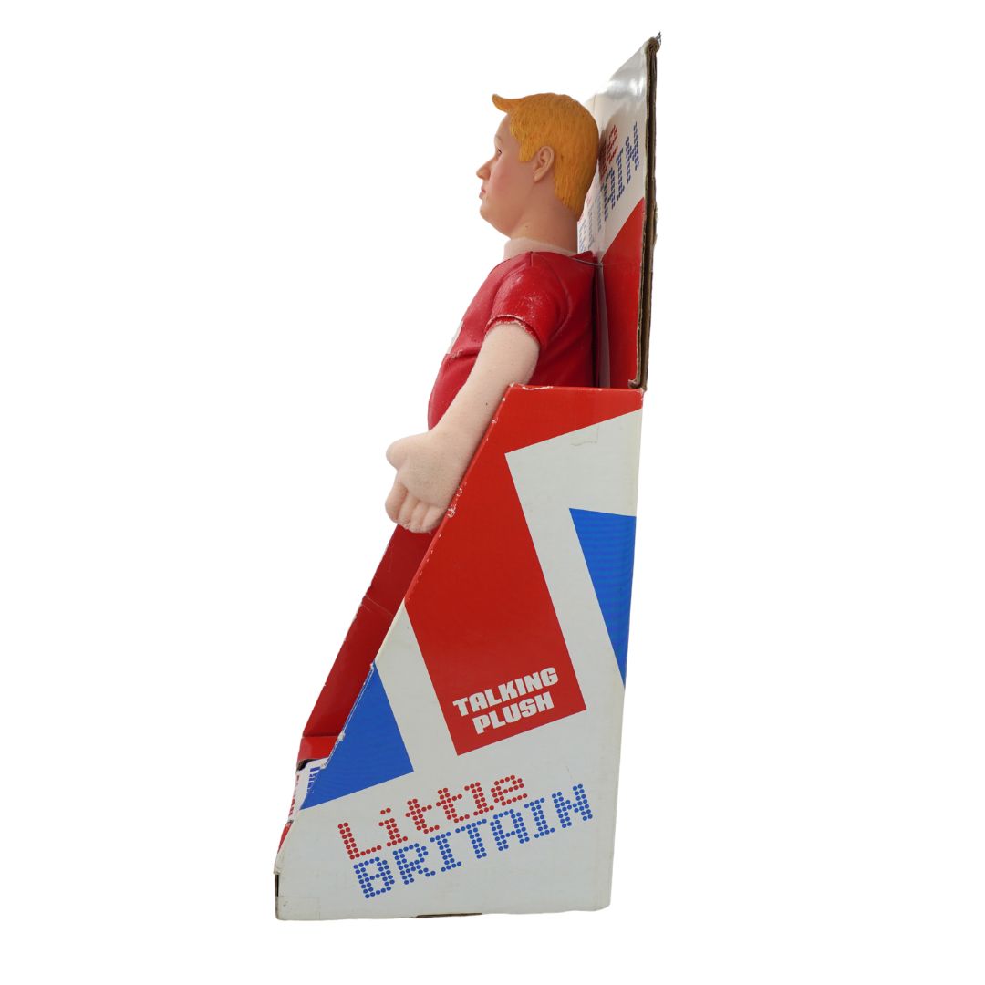 A vintage 'Little Britain' Talking Plush toy figure with blond hair and a red shirt, emerging from its red, white, and blue cardboard display box against a white background.