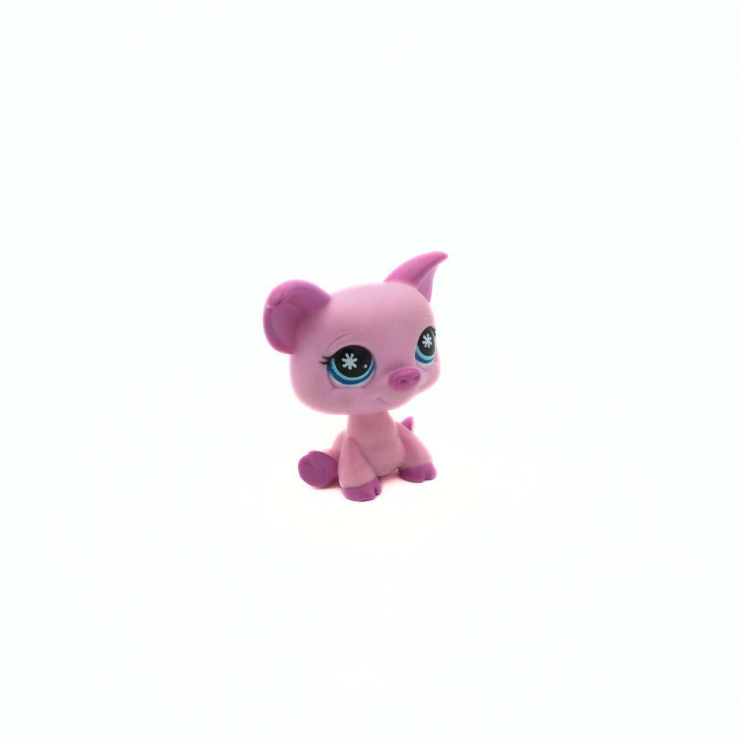 Small pink toy figure with blue eyes on a white background