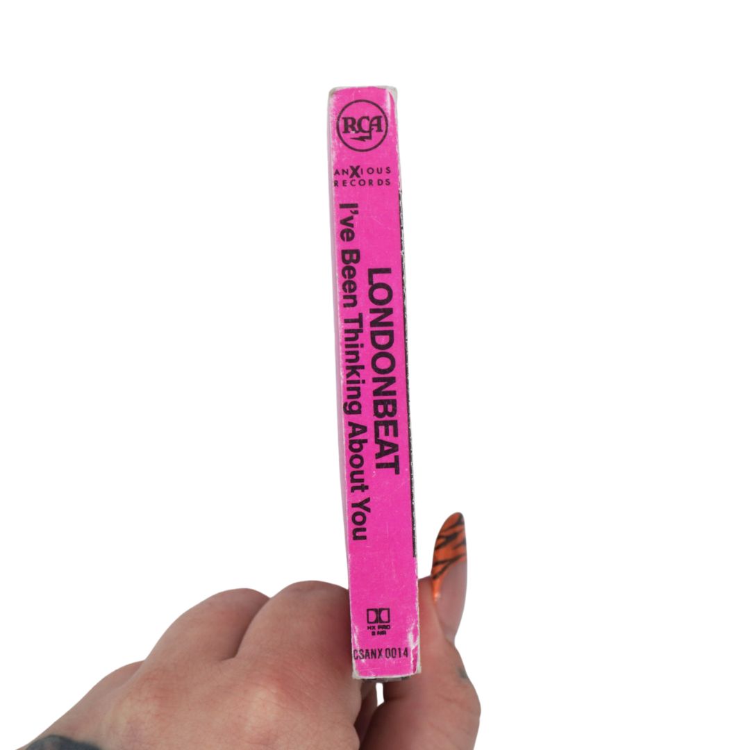 A hand holding a bright pink vinyl record sleeve spine against a plain white background. The spine features black text reading 'LONDONBEAT' and 'I've Been Thinking About You', with RCA and Axiom Records branding visible.