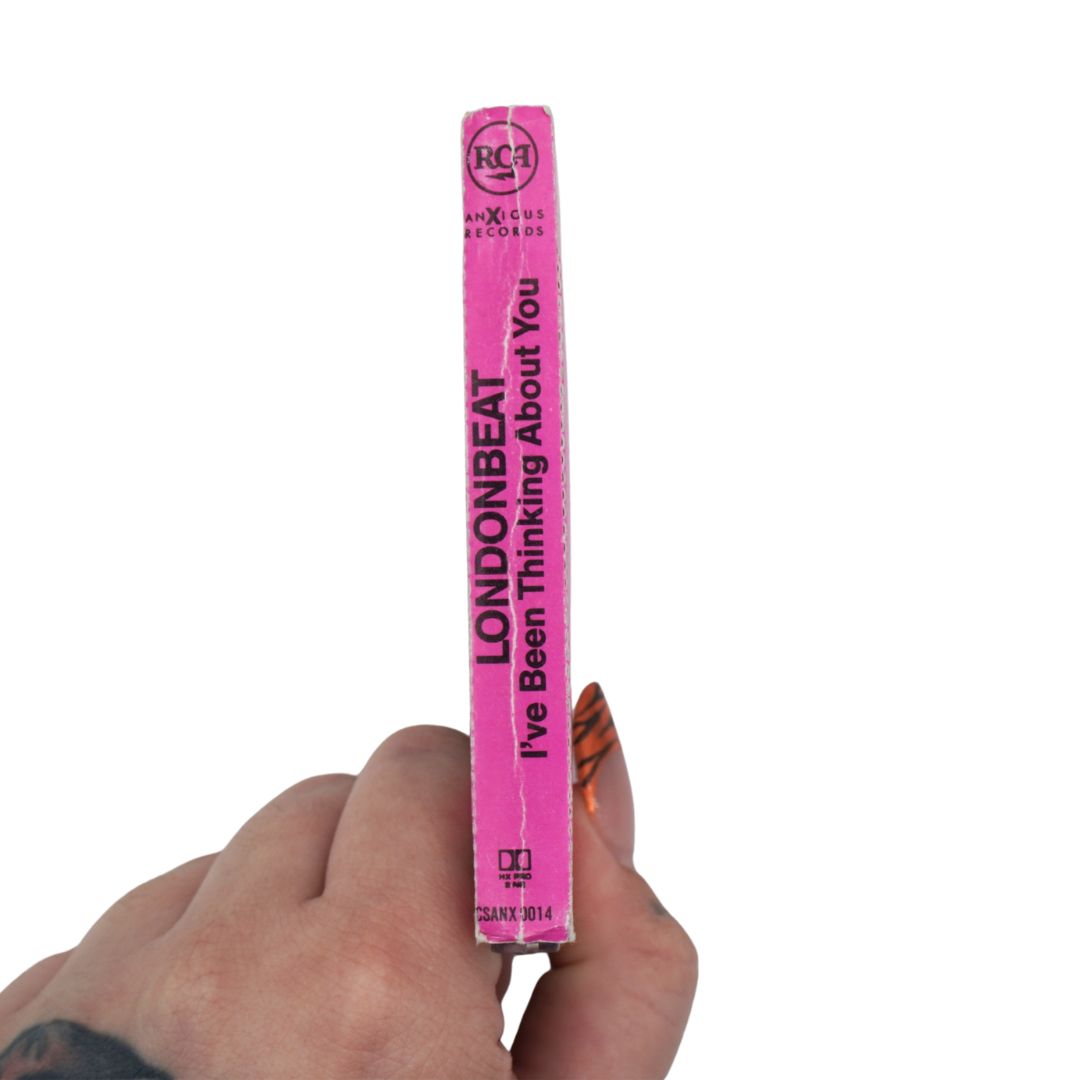 A hand holding a bright pink RCA Records sleeve for Londonbeat's 'I've Been Thinking About You' against a plain white background.