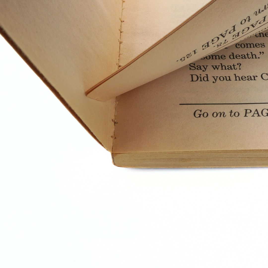 Close-up of an open book with text on a white background