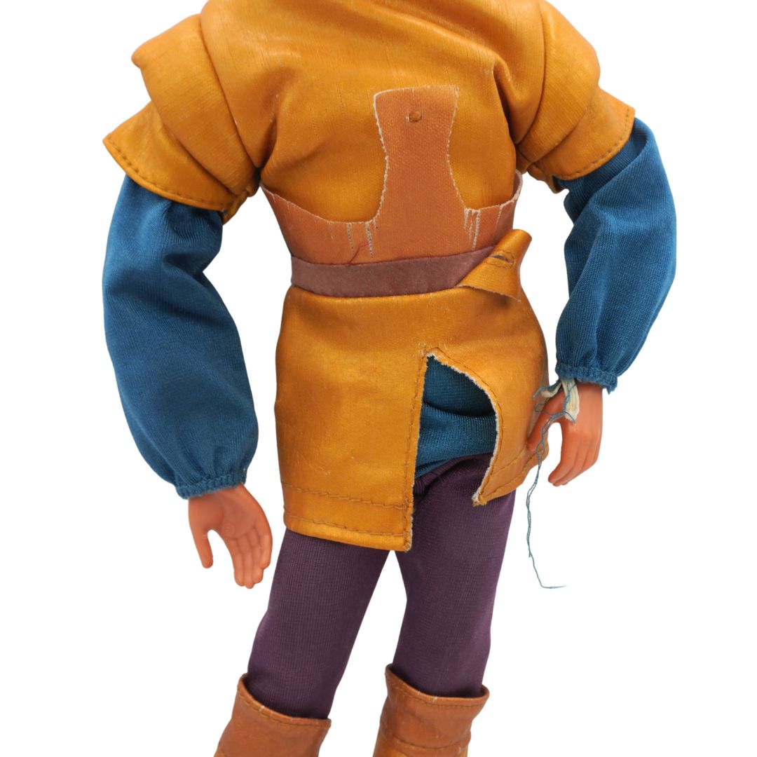 Action figure wearing a yellow leather outfit with blue sleeves on a white background