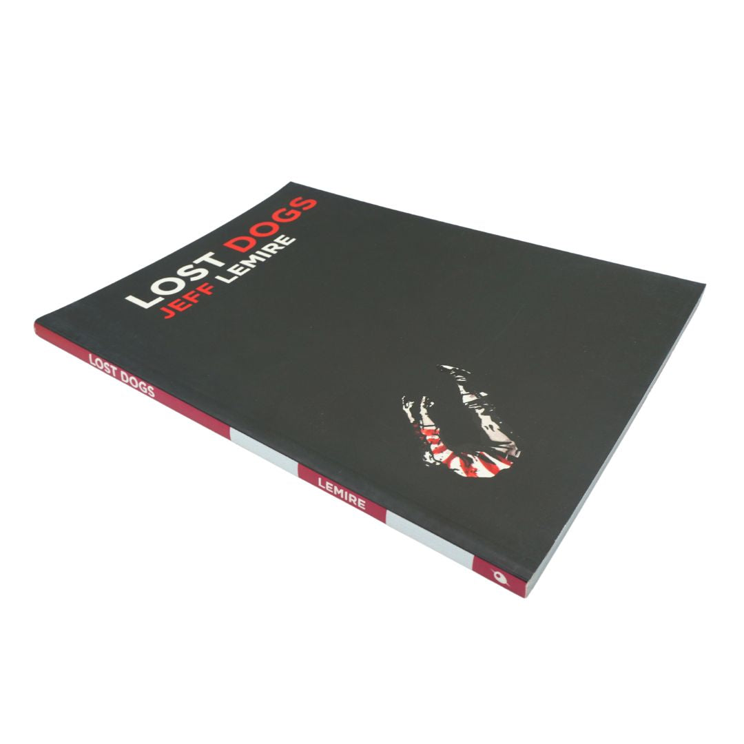 Black, white and red cover of the graphic novel Lost Dogs by Jeff Lemire on a white background