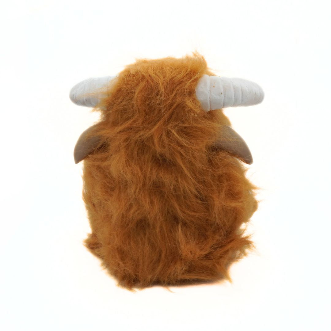Plush toy resembling a yak with brown fur and white horns on a white background