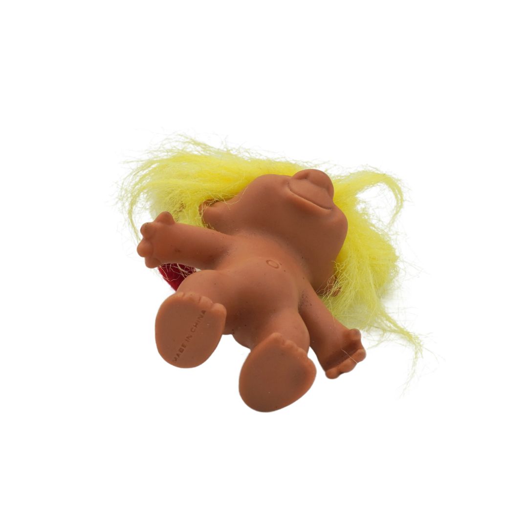 Toy figure with yellow hair on a white background