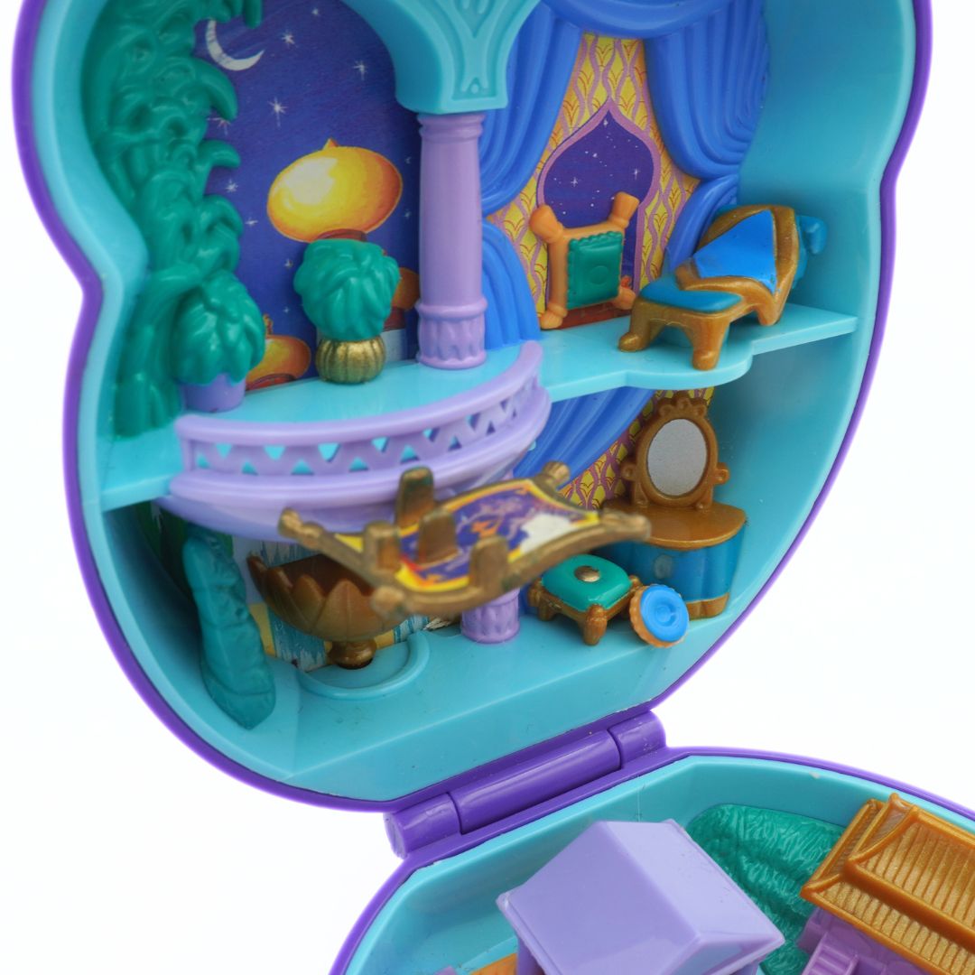 Toy dollhouse with colorful interior and exterior on a white background