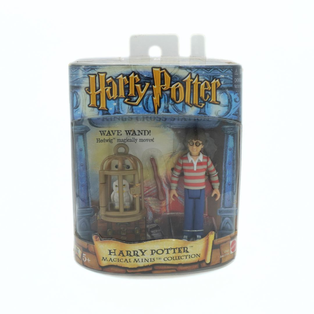 Harry Potter toy figure packaging with character and wand inside a cage.
