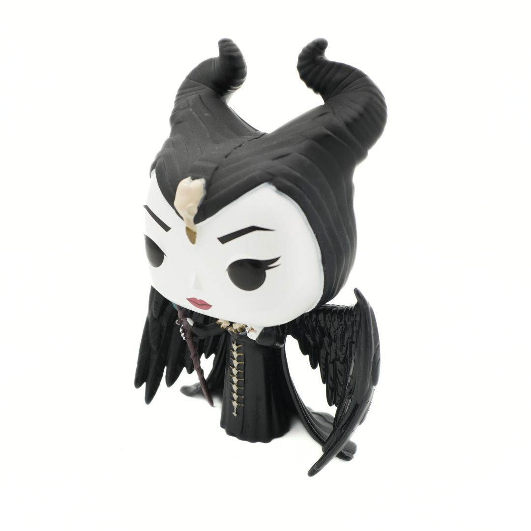 A Funko Pop! vinyl figure of Maleficent, featuring her signature black horns, white face, and black wings, set against a plain white background.