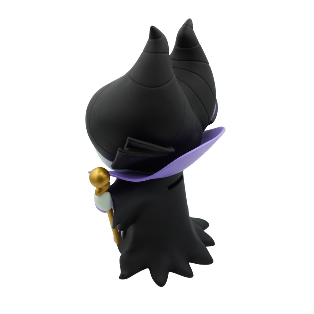 A green figurine wearing a purple and black jacket and black hat, holding a gold rod