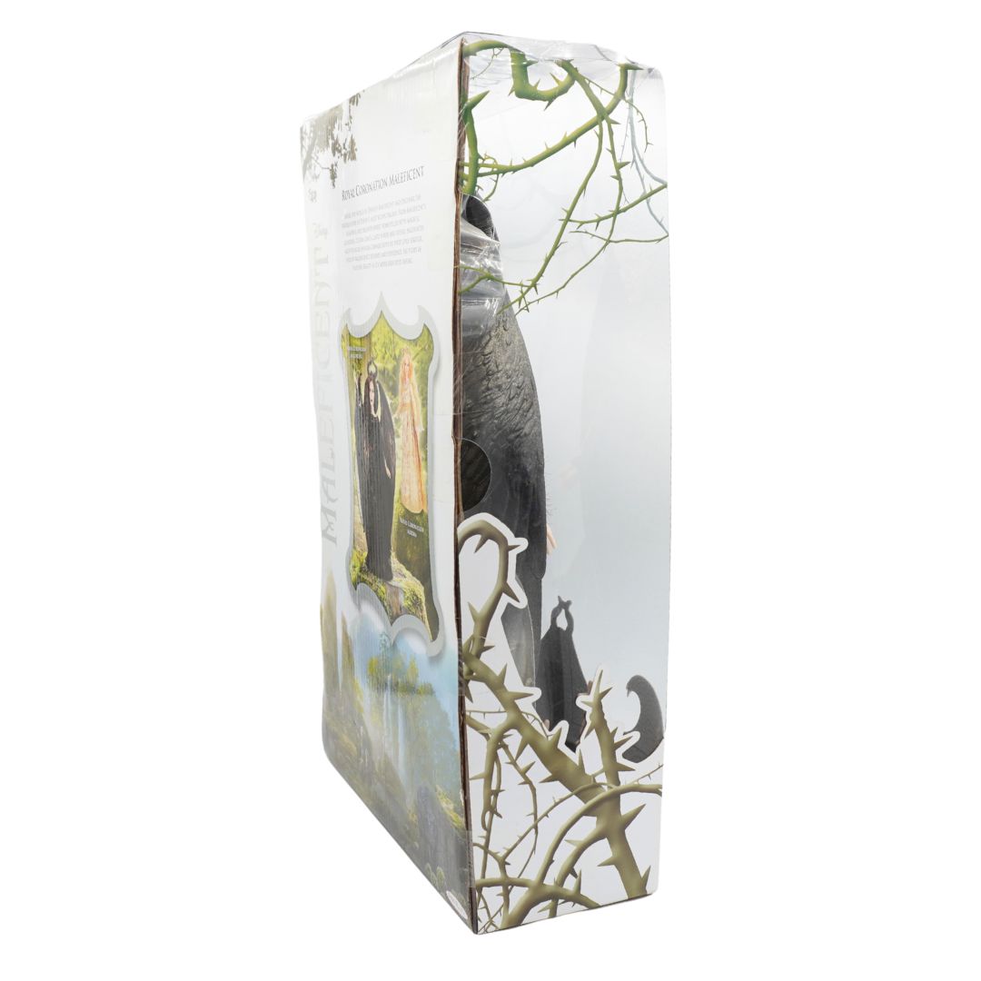 A boxed product photographed on a plain white background. The package appears to be a tall rectangular box with printed artwork showing a dark bird perched among bare branches, plus a small illustrated crest on the side panel.