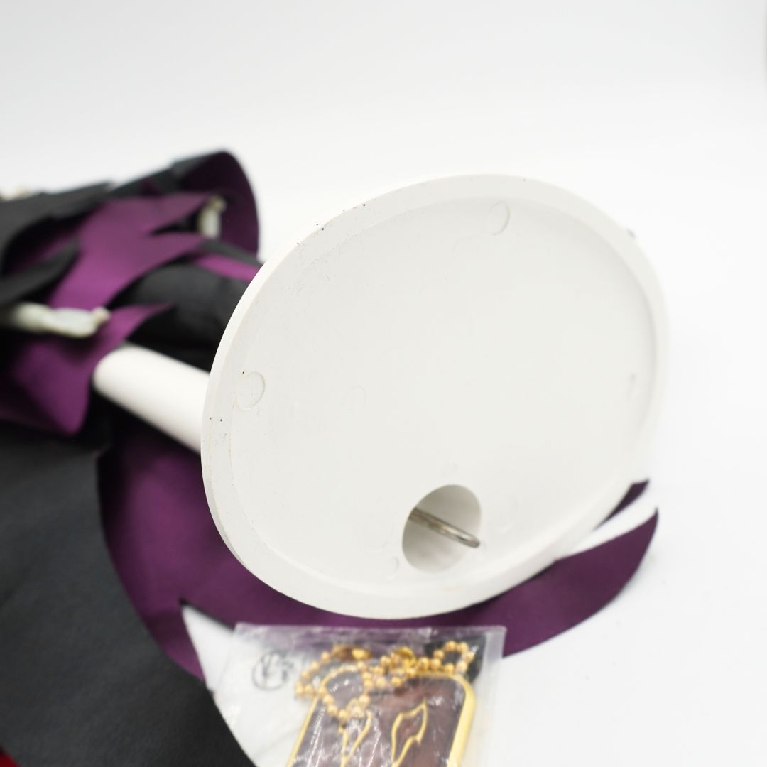 White underside of a stand holding a Disney Store Maleficent doll