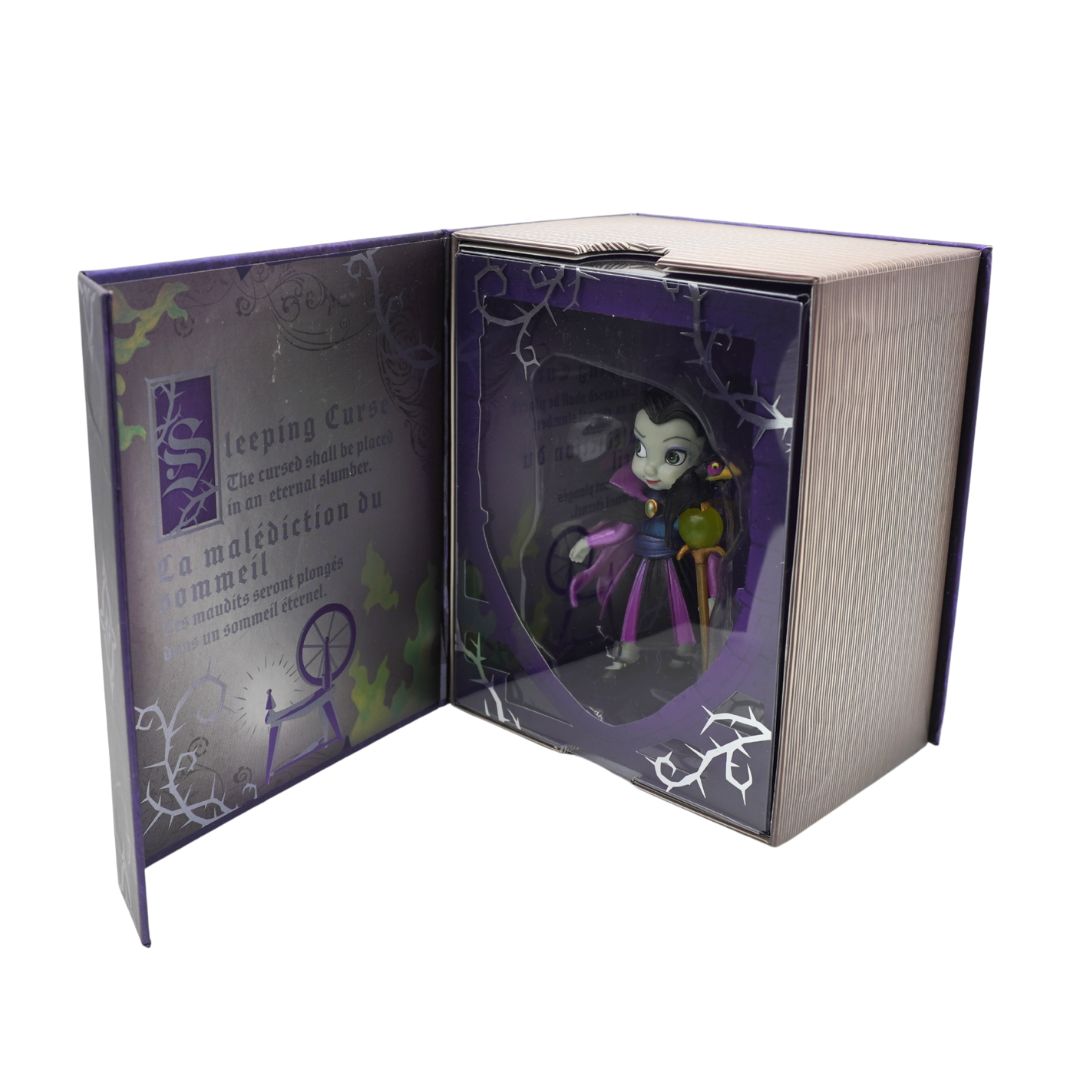 Figurine inside an open book-shaped box with decorative elements