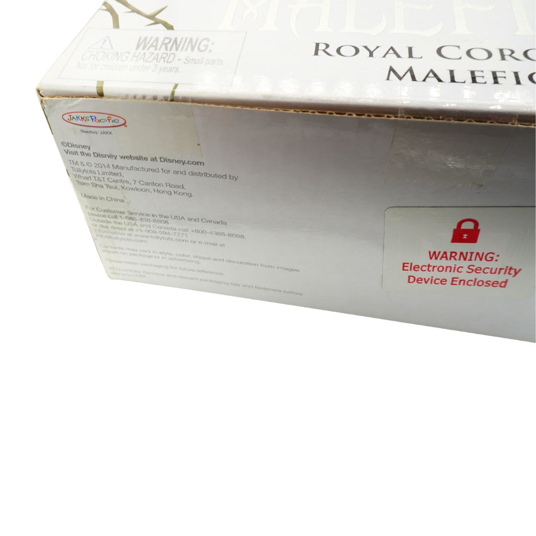 A close-up of a white product box with printed text including 'ROYAL CORONATION MALEFICENT,' a Disney website URL, and a red padlock warning label reading 'WARNING: Electronic Security Device Enclosed.'.