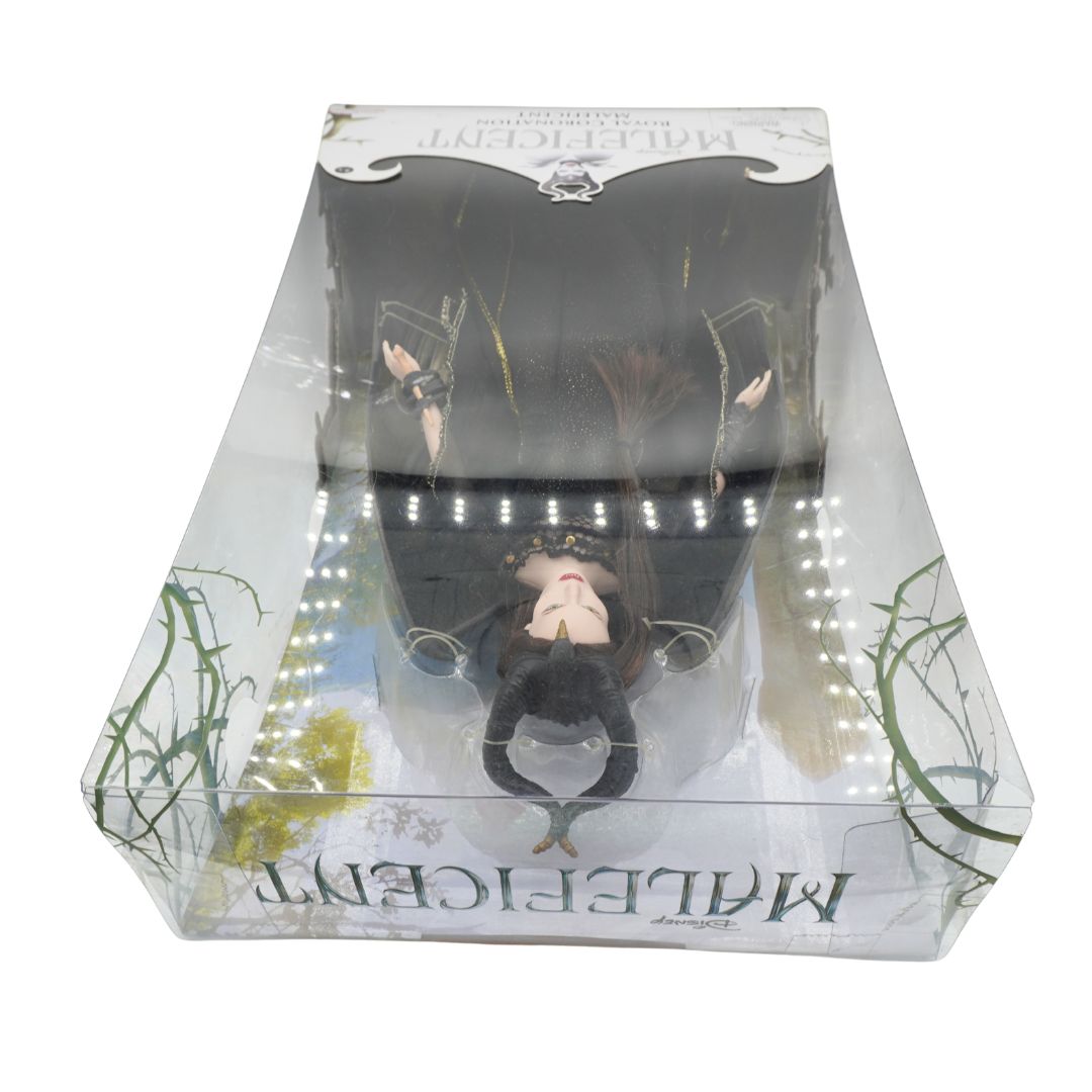 A packaged collectible figure of Maleficent from her eponymous film, displayed inside a clear plastic window box with printed artwork and the name Maleficent visible on the packaging.