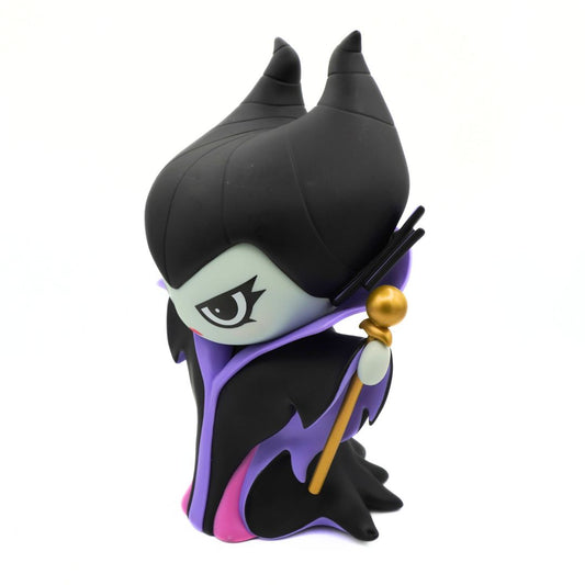 A green figurine wearing a purple and black jacket and black hat, holding a gold rod