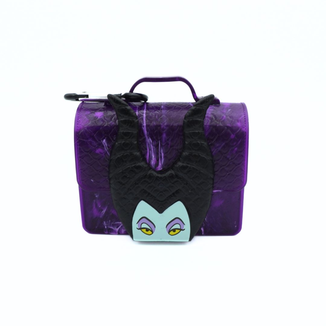 A purple textured lunchbox styled like Maleficent's hat, featuring black horns, a black face, and a light blue eye patch on the front, with a purple handle and zipper closure.
