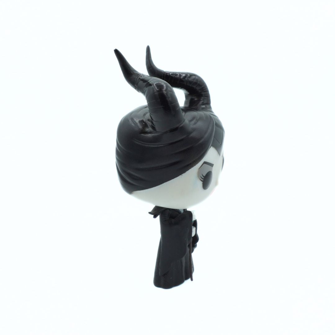 A stylized black and white horned character bust or figurine shown in side profile against a plain white background.