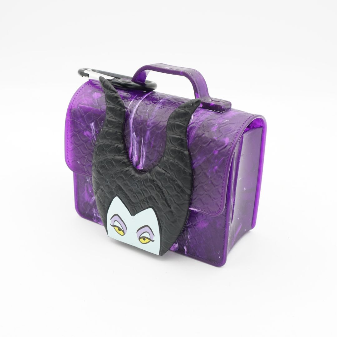 A purple faux-leather bag featuring a black horned character face with yellow eyes and a purple handle, shown on a white background.