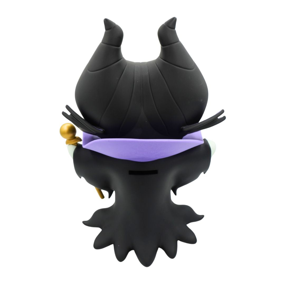 A green figurine wearing a purple and black jacket and black hat, holding a gold rod