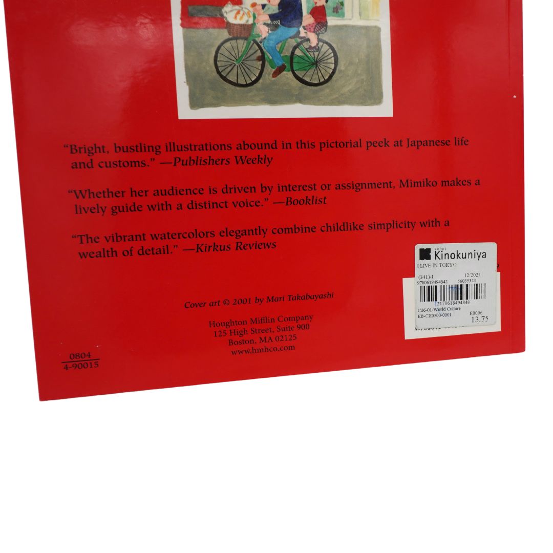 The back cover of a book, photographed on a white background. The cover is predominantly red with a small illustration of a child riding a bicycle at the top, several review quotes below, publisher text, a barcode, and a Kinokuniya logo.