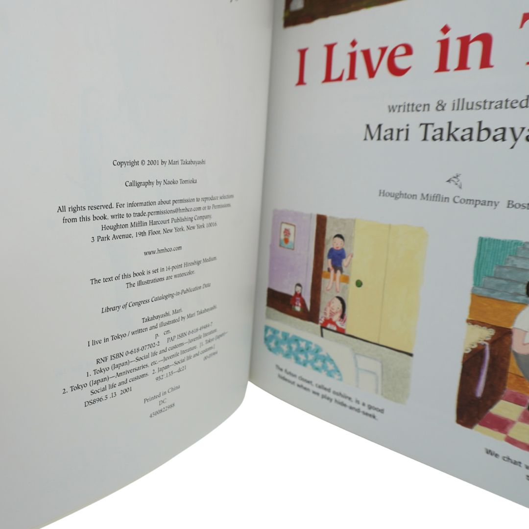An open book showing printed pages, including a title page with the text 'I Live in Tokyo'