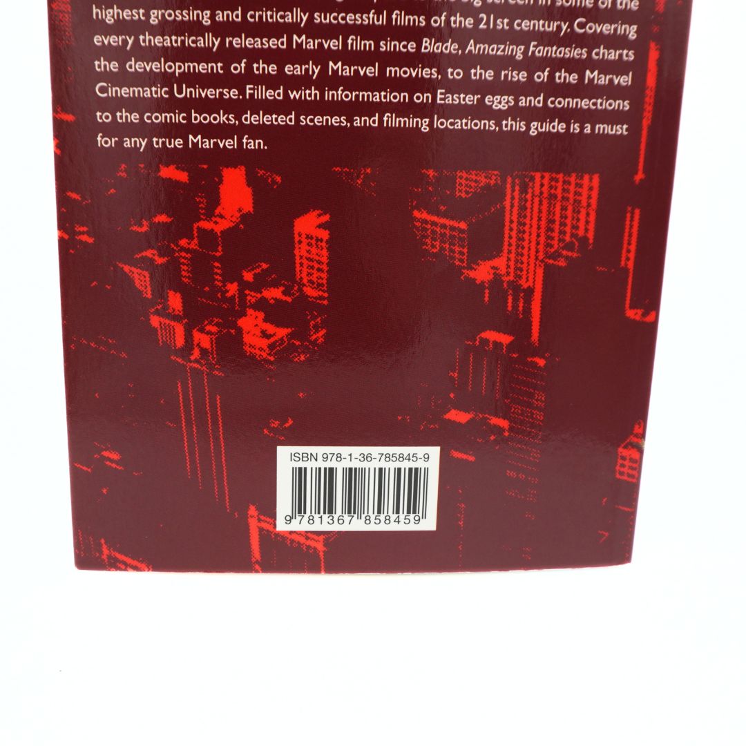 The back cover of a Marvel guide book featuring a dark red background with a red cityscape graphic, white text, and a barcode near the bottom.
