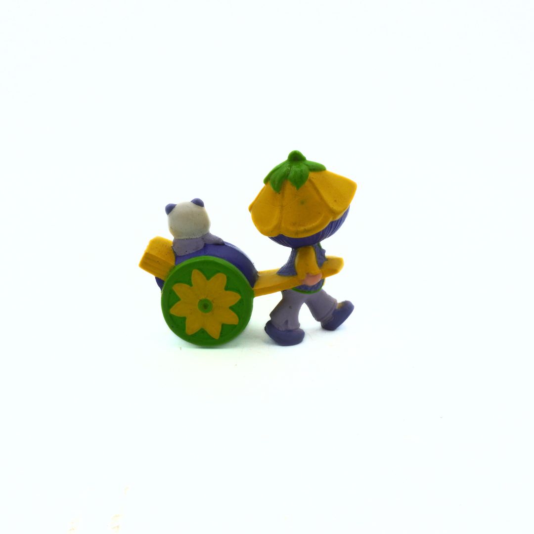 Two small figurines with a cart on a white background