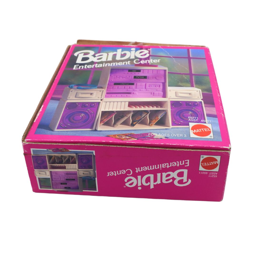 Vintage Mattel Barbie Entertainment Center toy box in pink packaging, showing the purple and white toy set pictured on the lid and side panel.