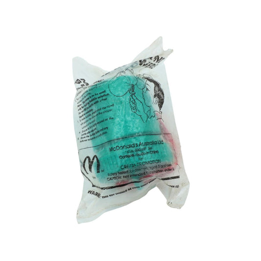 A sealed plastic bag containing a McDonald's Australia limited edition toy, featuring a turquoise blue figure with a black hair tuft and black printed text and logo.