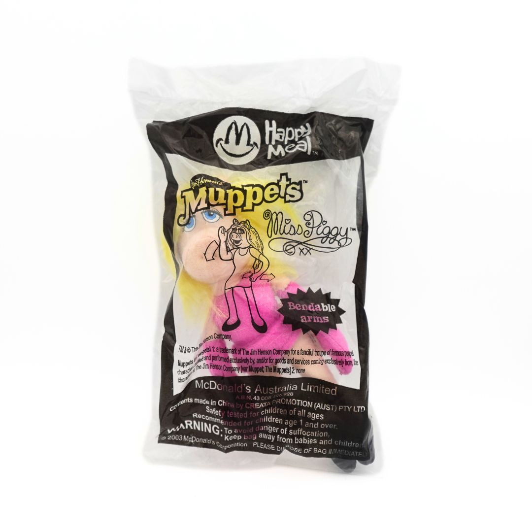 Front on photo of a 2003 McDonalds Happy Meal toy of the Muppets character Miss Piggy