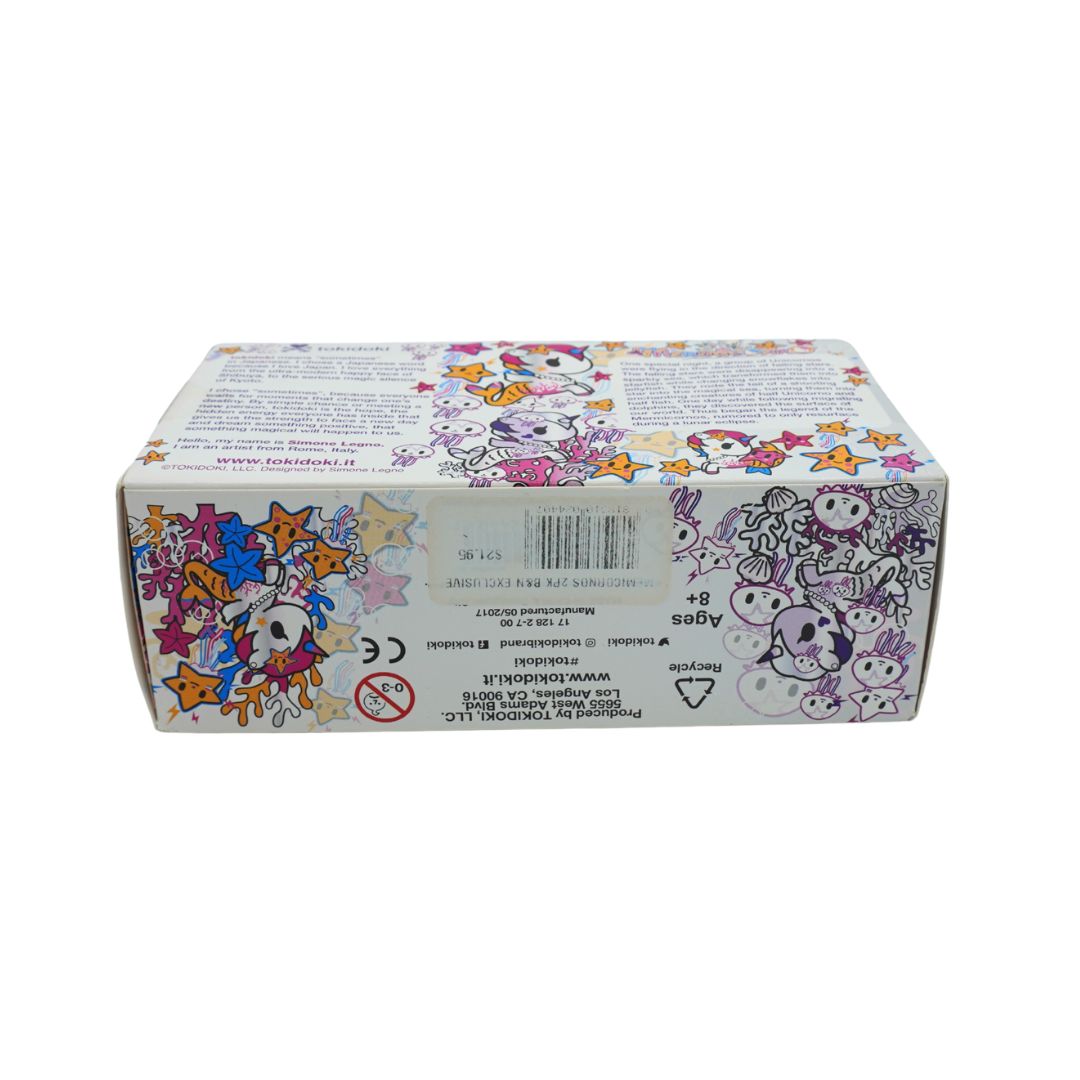 Photo of a colourful Mermicorno Tokidoki box with a set of two purple and white vinyl figurines