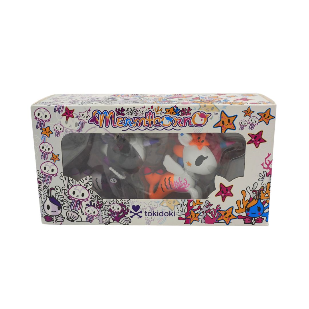 Photo of a colourful Mermicorno Tokidoki box with a set of two purple and white vinyl figurines