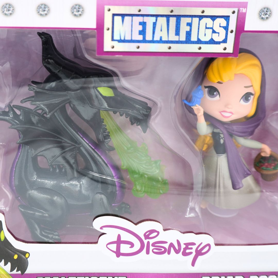 Disney Metalfigs Maleficent and Briar Rose set in its original blister packaging, featuring a chibi-style Rapunzel figure and a black dragon with green fire breath.