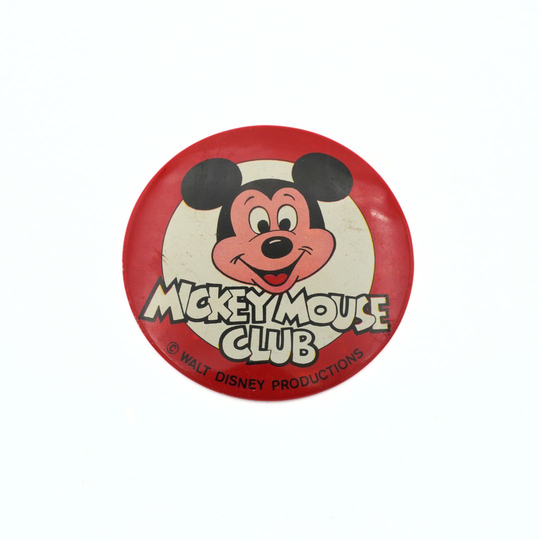 Button badge with Mickey Mouse Club logo on a white background