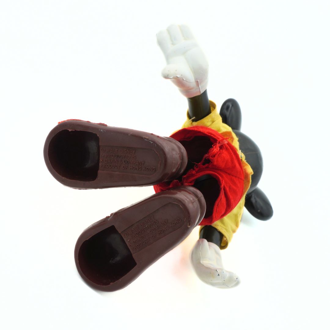 Mickey Mouse toy with shoes on a white background