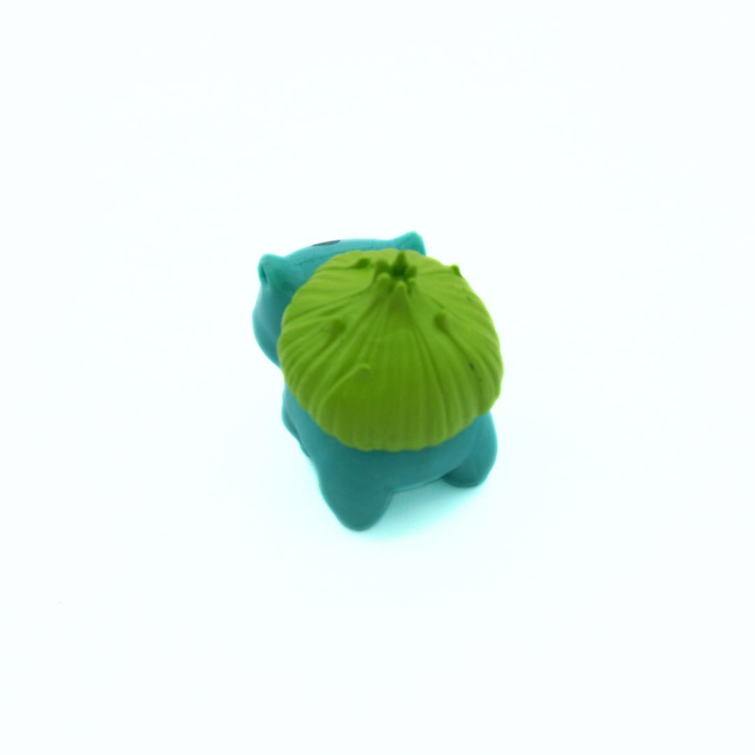 Blue and green figurine on a white background