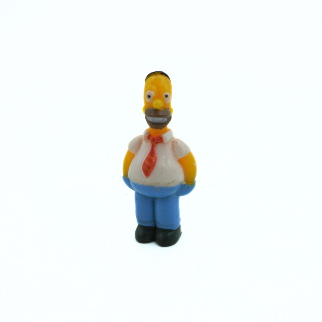 Small figurine of a character from 'The Simpsons' on a white background
