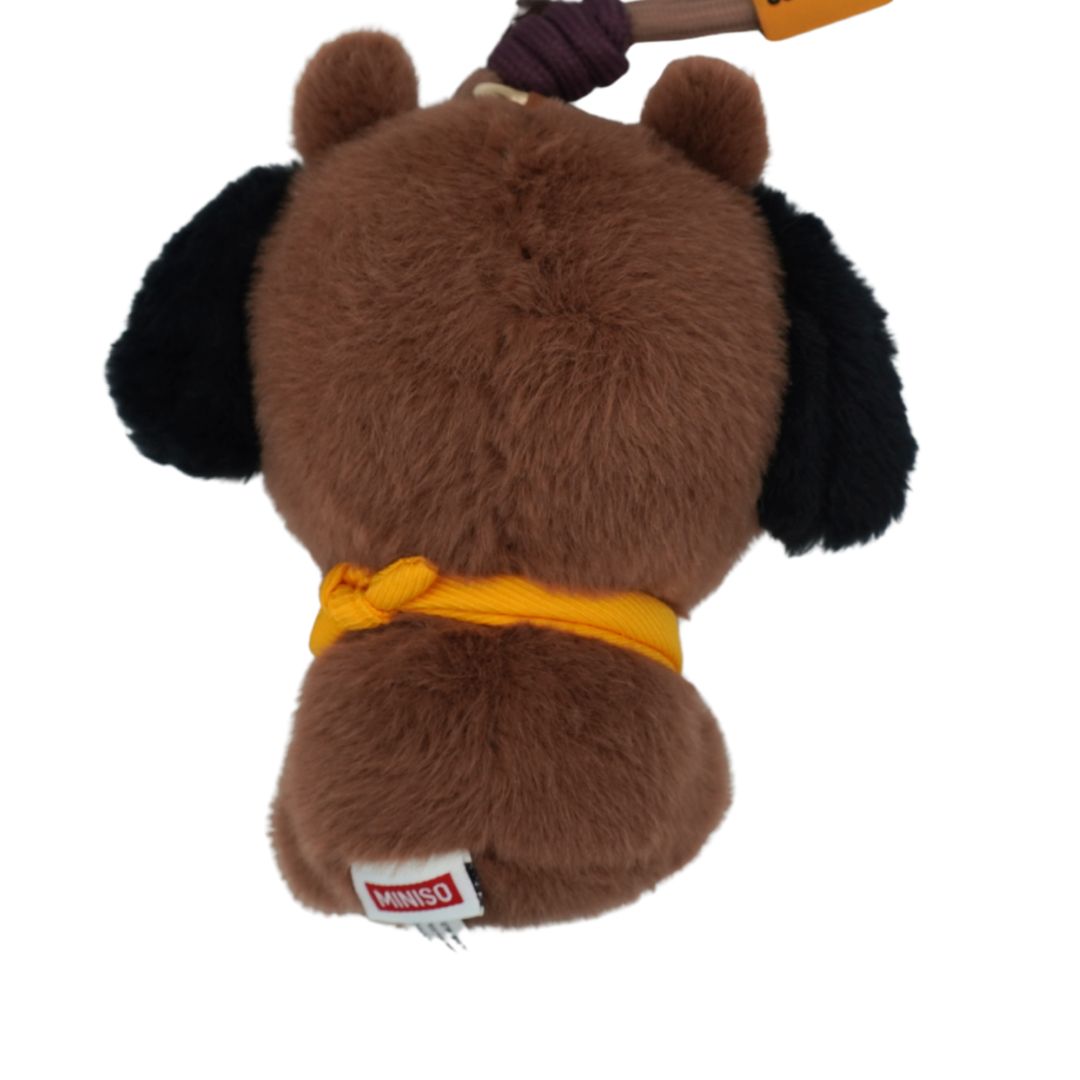 A brown plush dog toy shown from the back, featuring black ears, a yellow rope collar, and a small Minus0 brand tag near the tail. A dark purple and orange rope is tied to the top.
