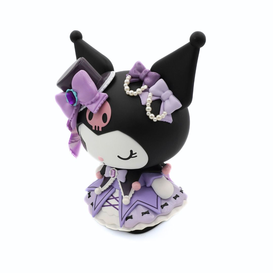 A cute black cartoon character figurine with a white face, wearing a purple and lavender gothic-style dress, hat, and bow, decorated with pearl beads and a small purple gem, set against a plain white background.