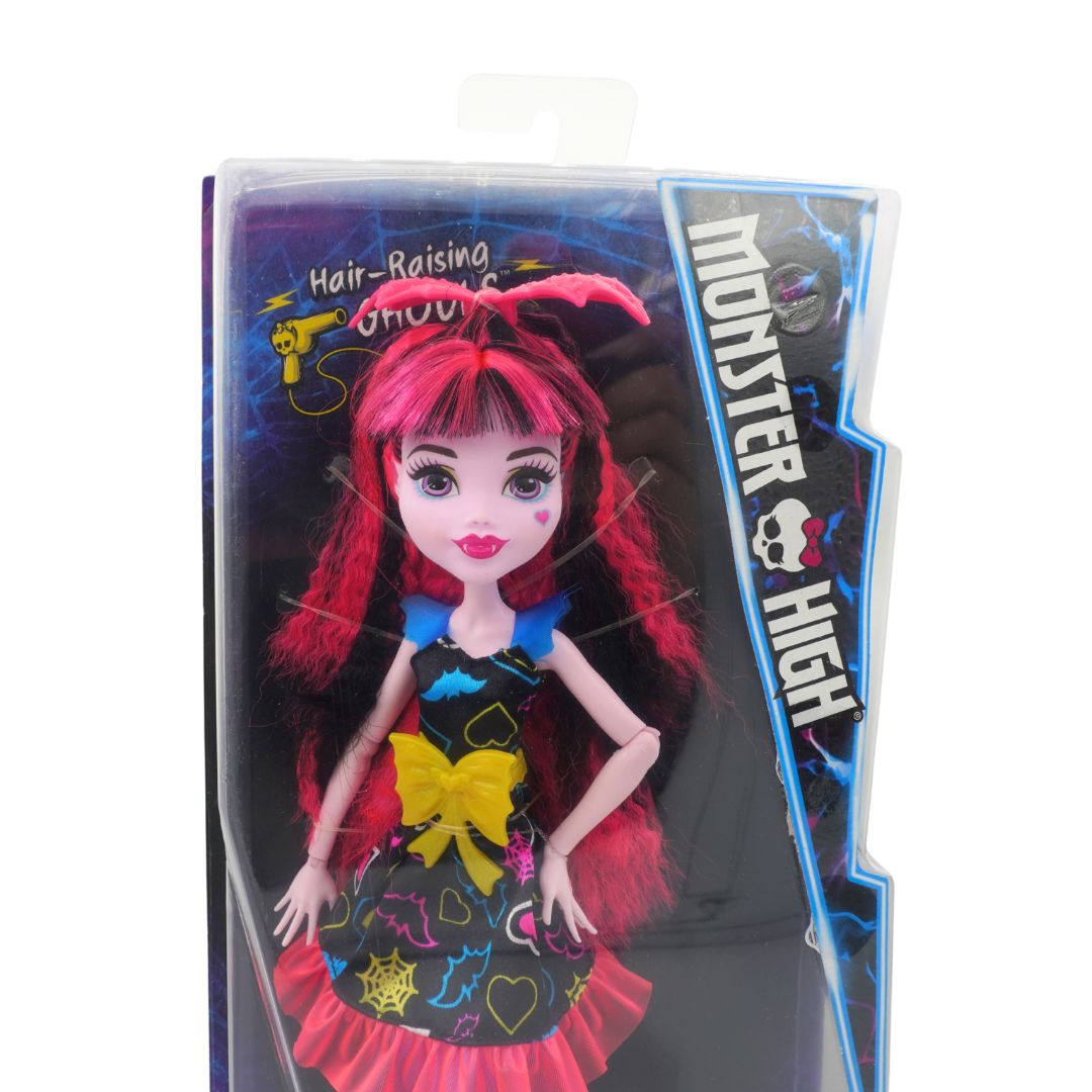 Monster High doll in packaging with red hair and colorful dress
