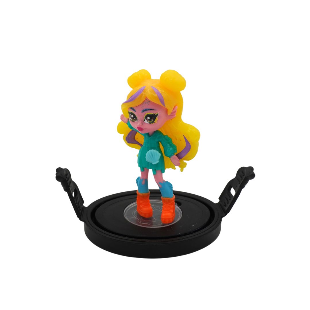 A small stylized doll figure with yellow hair, a teal top, blue leggings, and orange boots, standing on a black circular display base against a plain white background.