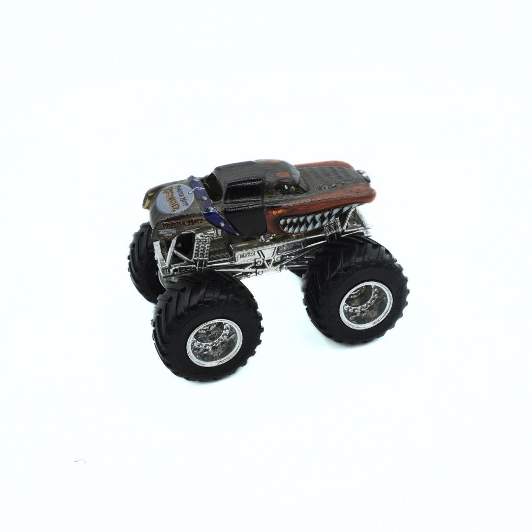 A miniature die-cast toy monster truck with oversized black tires, a black and silver body, and a brown hood, shown on a plain white background.