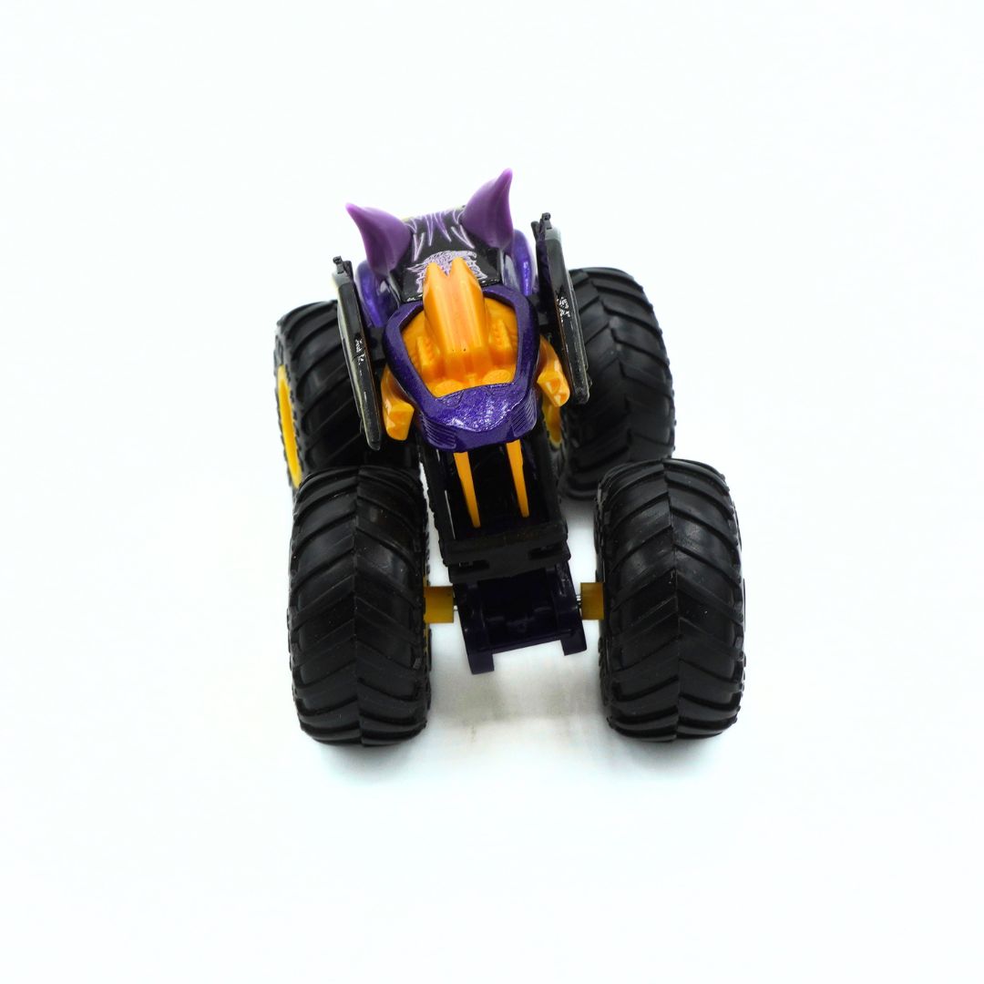 A small monster truck toy with oversized black tires, a purple and orange body, and yellow accents, photographed on a plain white background.