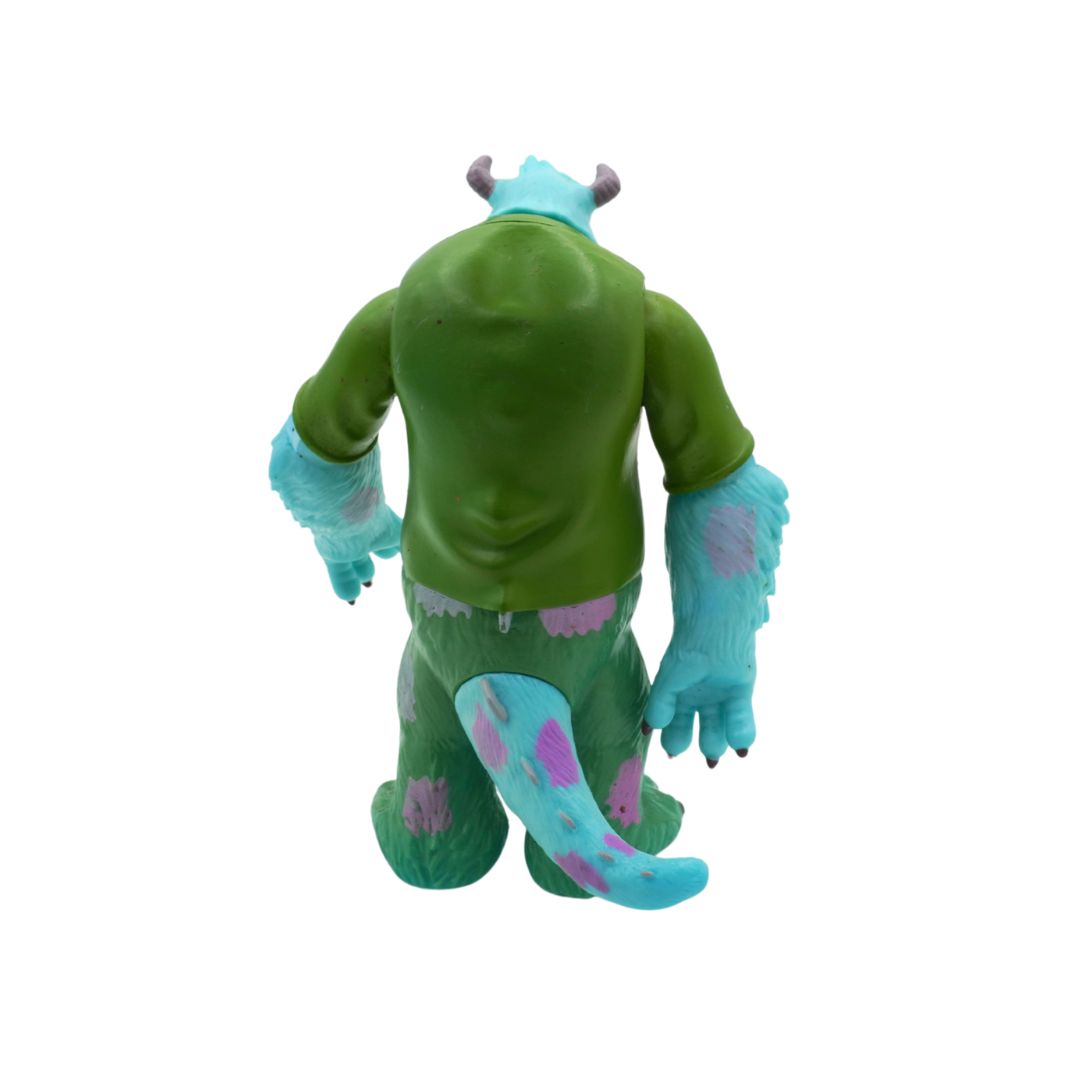 Green monster toy with blue accents on a white background