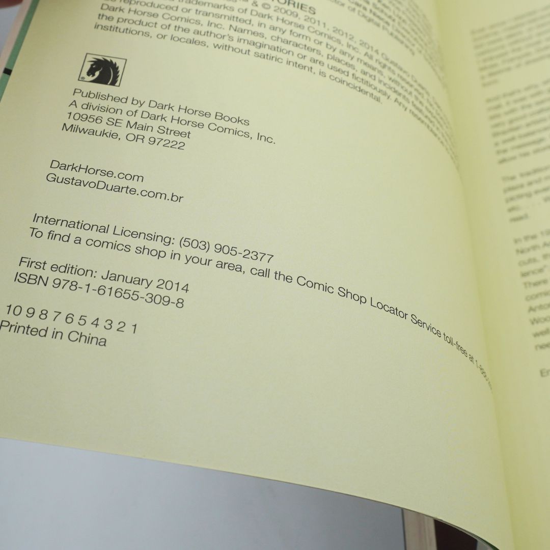 An open book page showing printed publication details, including publisher Dark Horse Books, ISBN, and printing information, photographed close up.