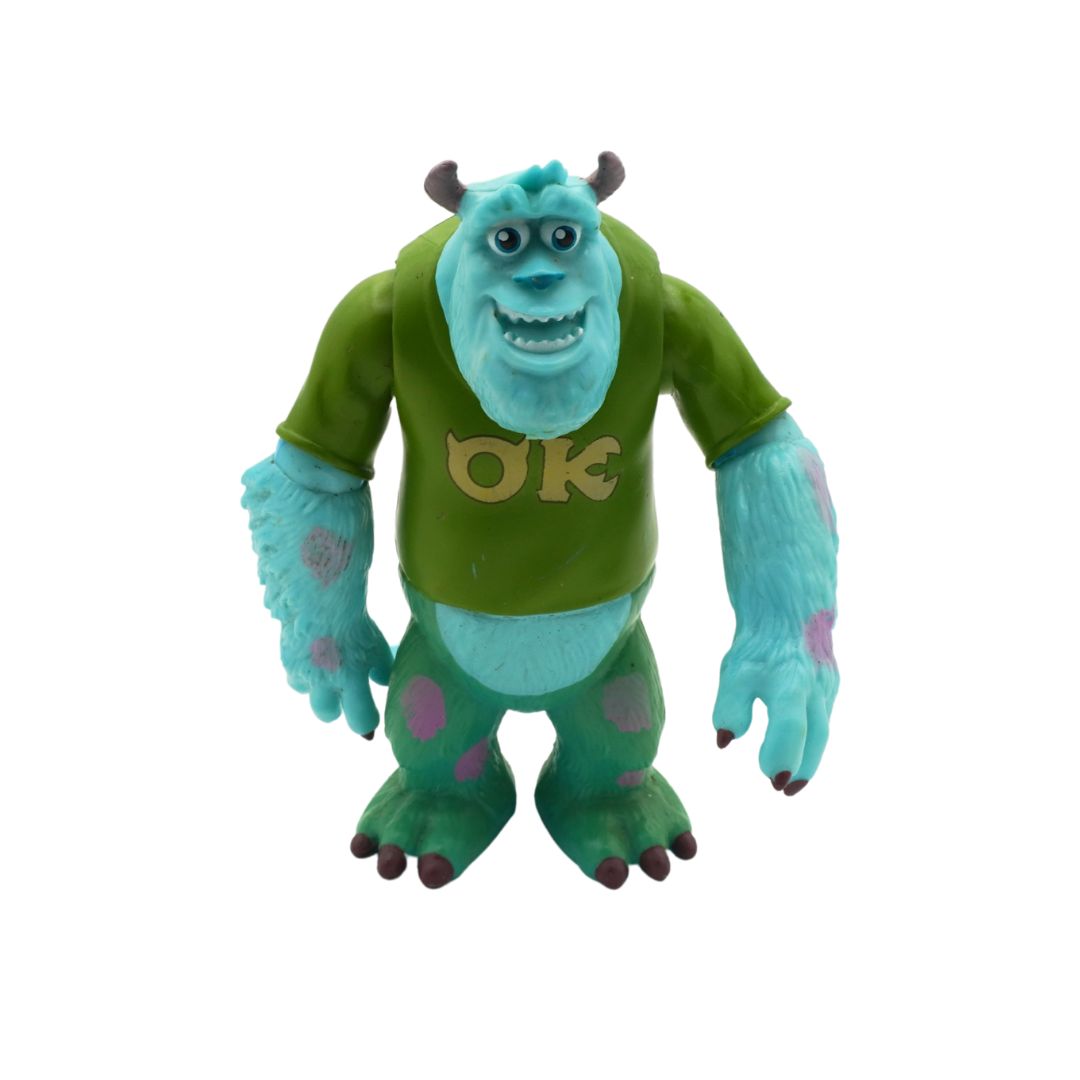 Toy figure of a character from a movie with green skin and a green shirt with 'OK' on a white background
