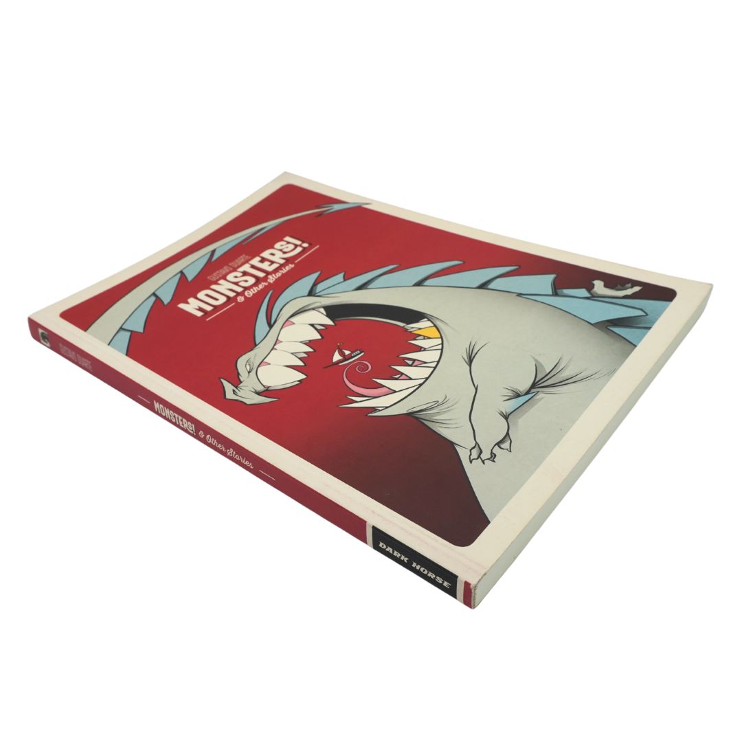 A hardcover art book titled 'Monsters!', featuring a stylized illustration of a green monster on a red cover, shown at an angle on a white background.