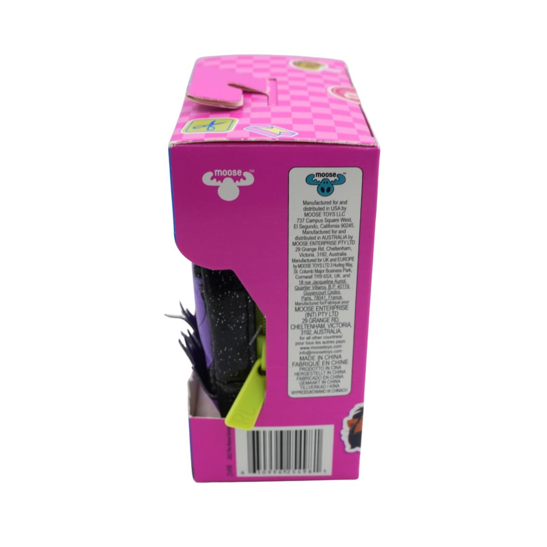 A boxed toy product shown from the back side, featuring a bright pink box with a checkered pattern, a clear window revealing a black glittery plush or toy inside, and a barcode label on the right side.